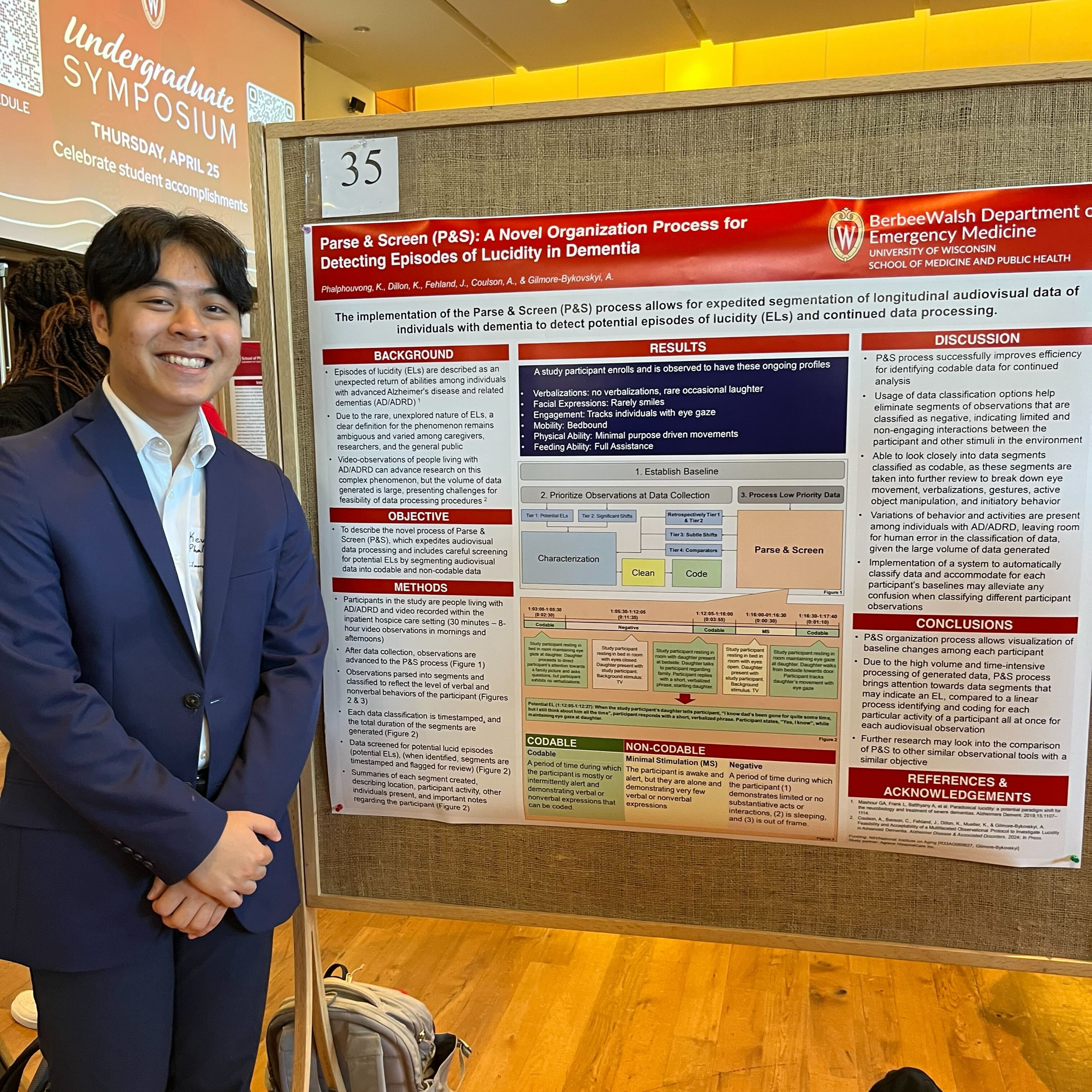 Kevin Poster Kevin stands next to his research poster.