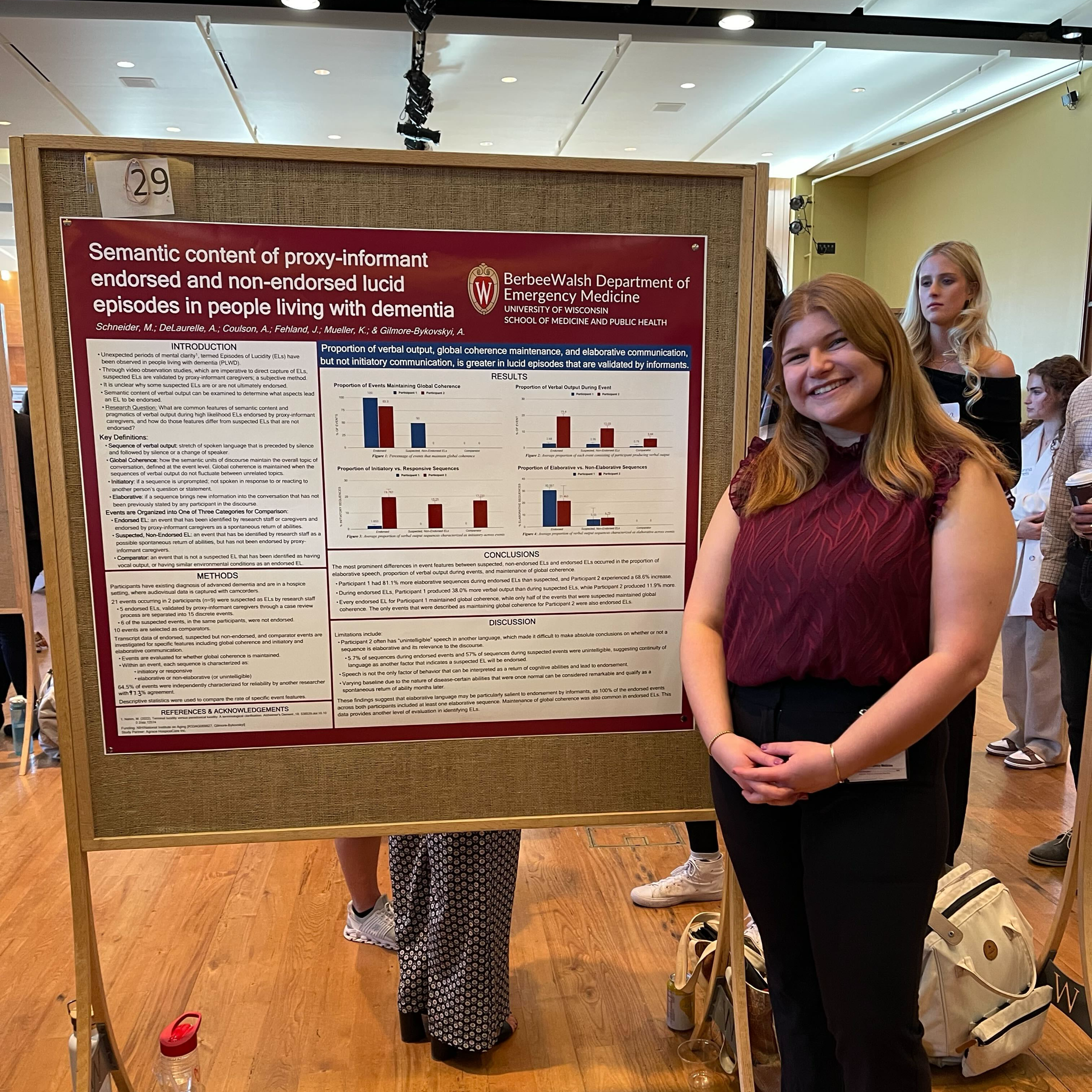 Maggie Poster Maggie stands next to her research poster.